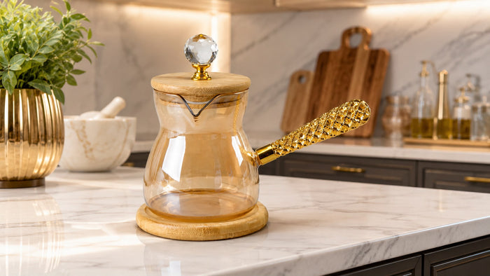 Trendiest amber borosilicate glass coffee pot with bamboo lid, crystal knob, and textured gold handle on marble counter