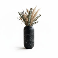 Trendiest ceramic vase in matte black with white marble veining, filled with dried pampas grass and eucalyptus stems.