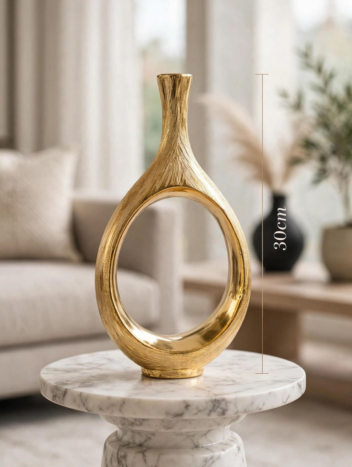 Trendiest brushed gold ceramic vase with a modern hollow circle design, displayed on a marble table in a living room.