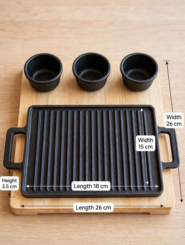 Trendiest cast-iron grill plate with three sauce bowls on a wooden serving board, shown with dimensions.