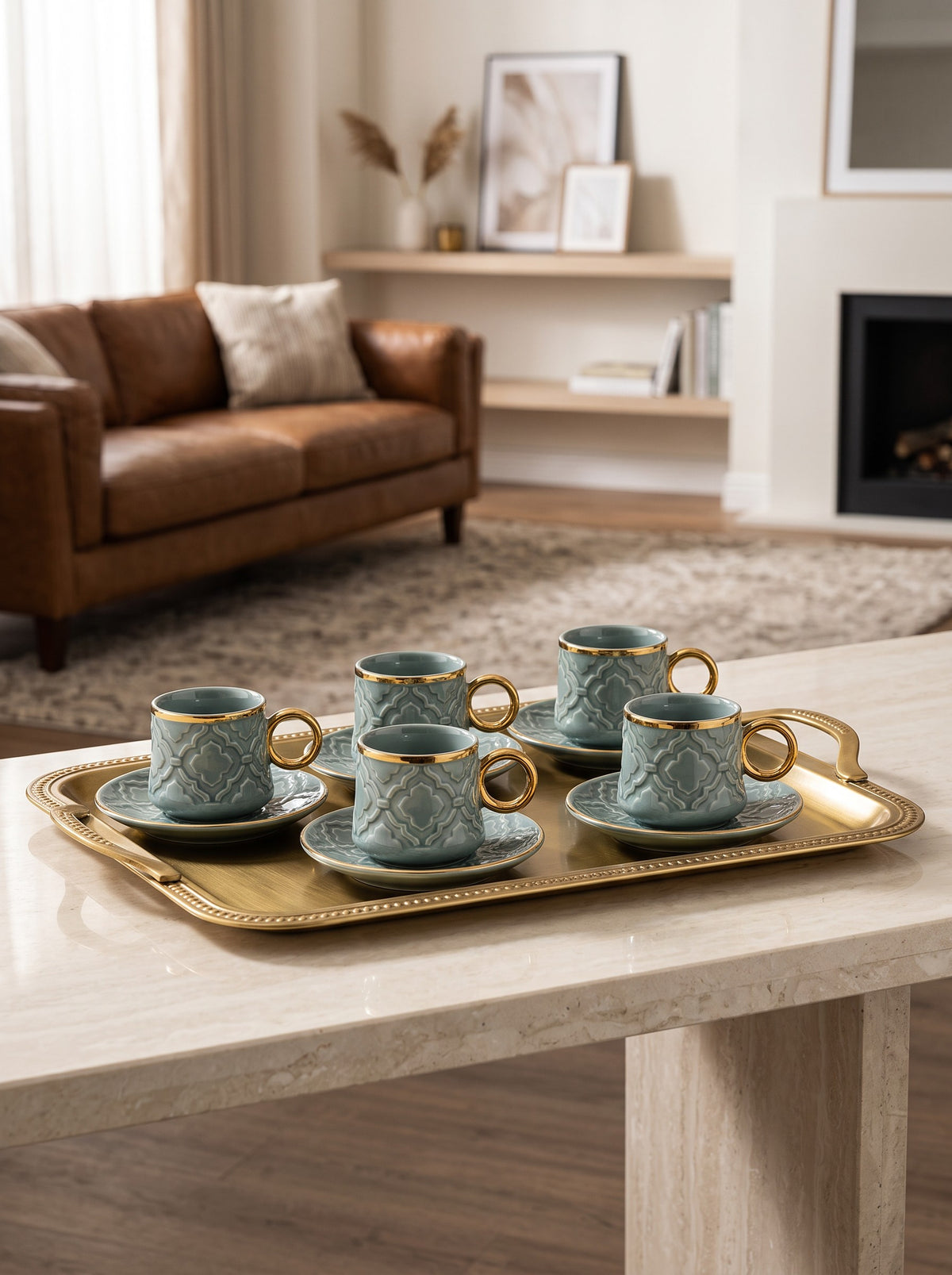 Trendiest ceramic coffee cup and saucer set in sage green with embossed geometric patterns and gold-tone rims on a tray