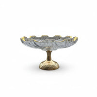 Trendiest glass serving bowl with a gold-tone rim and an intricately detailed pedestal base on a white background.