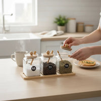 Trendiest glass spice jar set with bamboo lids, wooden spoons, and display tray on a kitchen counter