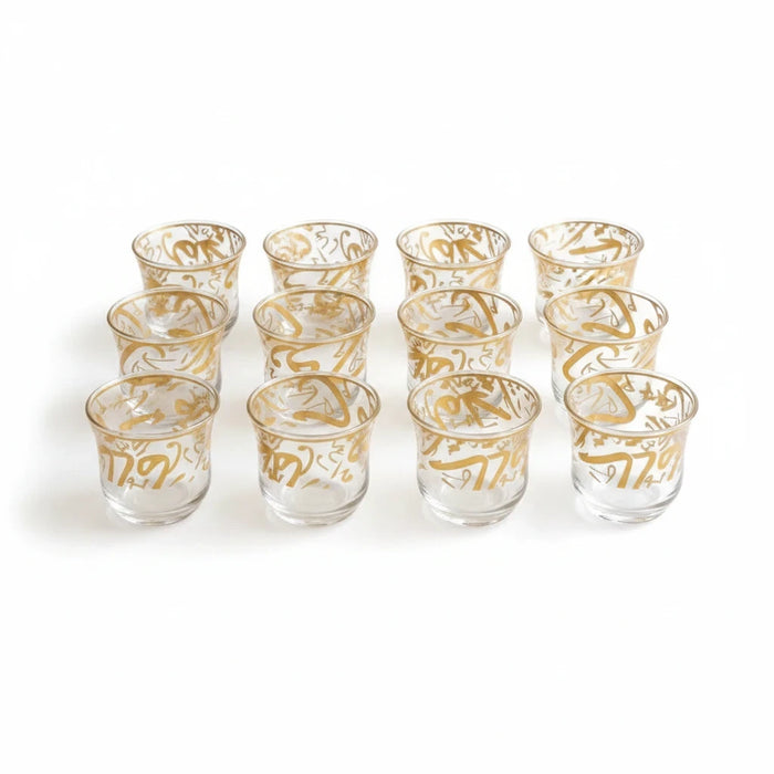 Trendiest decorative tea cup set featuring clear glass with intricate gold Arabic calligraphy detailing.