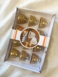 Trendiest decorative tea cup set featuring clear glass cups with intricate gold Arabic calligraphy in a gift box.