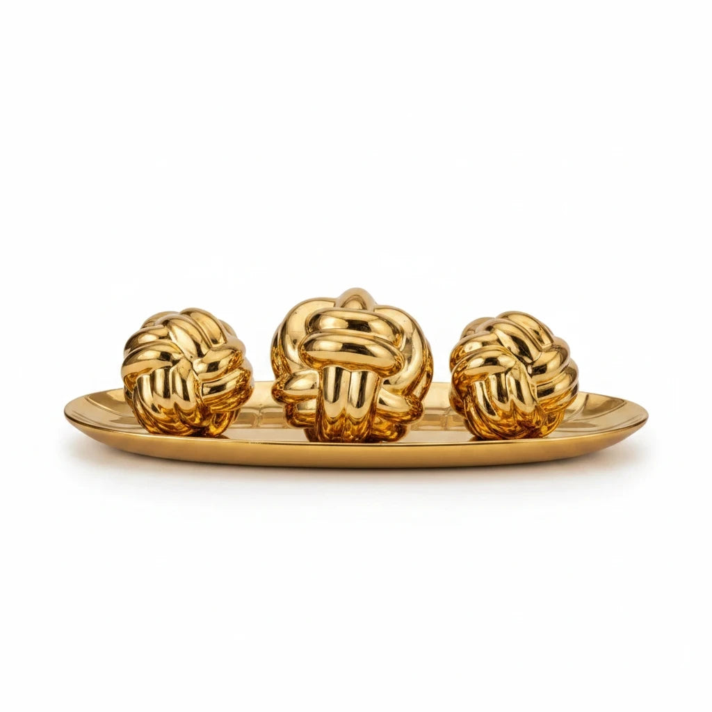 Trendiest decorative set featuring three gold knot sculptures displayed on a matching oval tray for modern home decor.