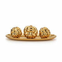 Trendiest decorative set featuring three gold knot sculptures displayed on a matching oval tray for modern home decor.