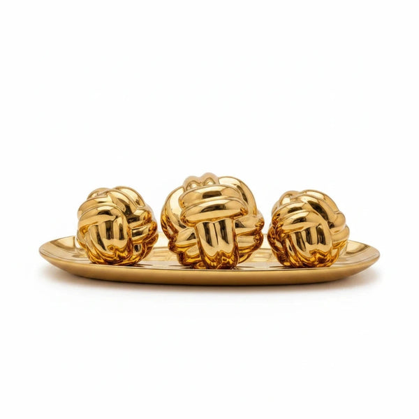 Trendiest decorative gold knot sculpture set featuring three polished spheres on an oval display tray.