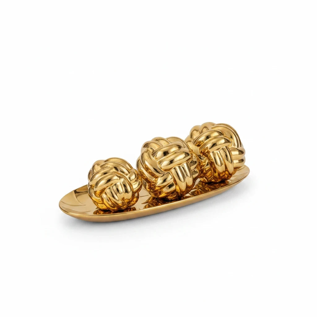 Trendiest decorative gold knot sculpture set featuring three metallic spheres on an oval display tray