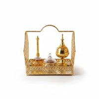 Trendiest gold metal bakhoor tray with intricate lattice design, incense burner, and perfume bottles on mirrored base.