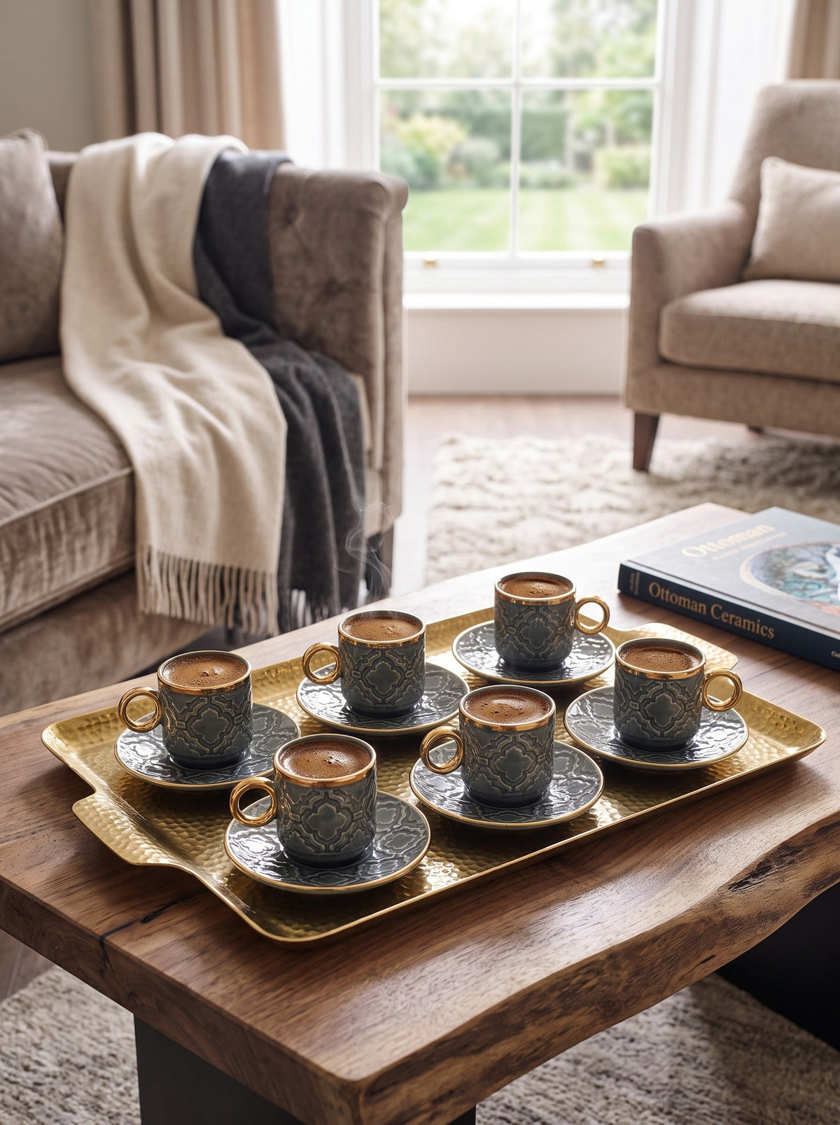 Trendiest set of five grey ceramic Turkish coffee cups with gold rims and embossed patterns on a gold serving tray.