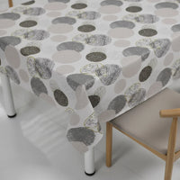 Trendiest grey geometric circle patterned tablecloth on a modern rectangular dining table with wooden chairs
