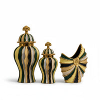 Trendiest hand-painted ceramic urn vase with gold, emerald, navy, and ivory finish in a decorative display.