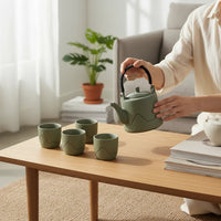 Trendiest high-fired porcelain tea set in sage green with mountain motif, featuring a teapot and matching tea cups.