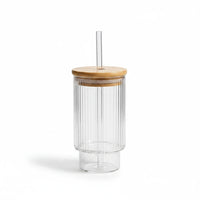 Trendiest ribbed glass tumbler with a bamboo lid and reusable glass straw on a white background