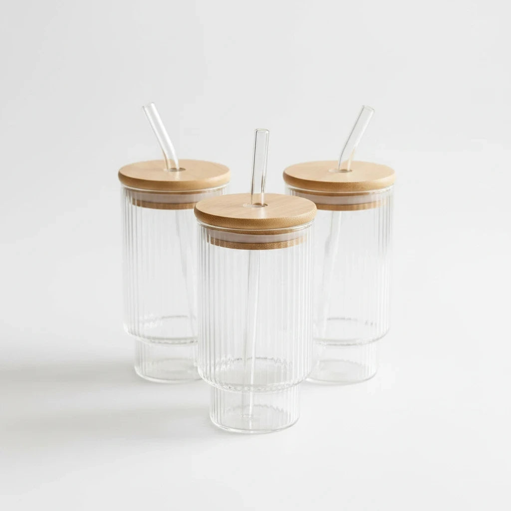Trendiest ribbed glass tumbler set featuring three clear glasses with bamboo lids and reusable glass straws